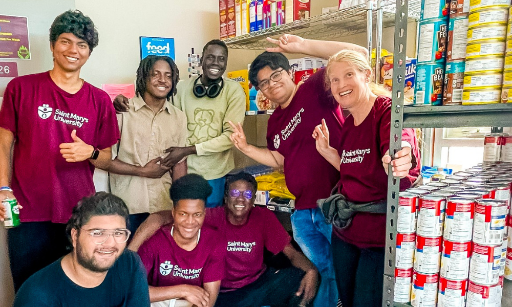 Students pose with shelves of packaged foods