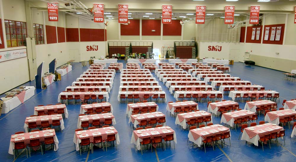 Homburg Gym set up for a banquet with rows and tables and chairs.