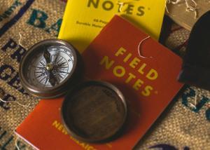 Photo of field notebooks with a compass