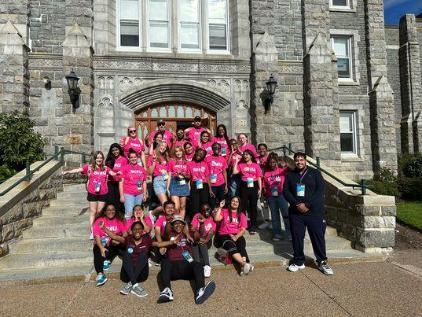 Group of pack leaders sitting together outside on the steps of a building